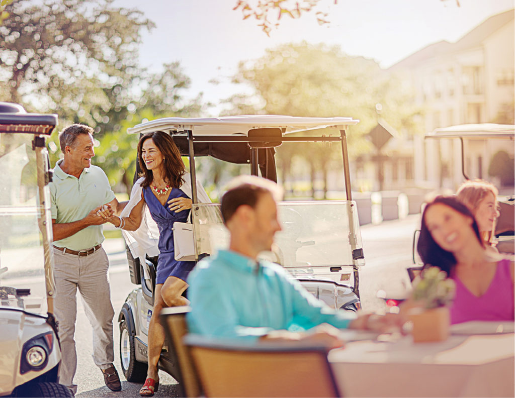 photo of people exiting golf cart to eat at curbside table