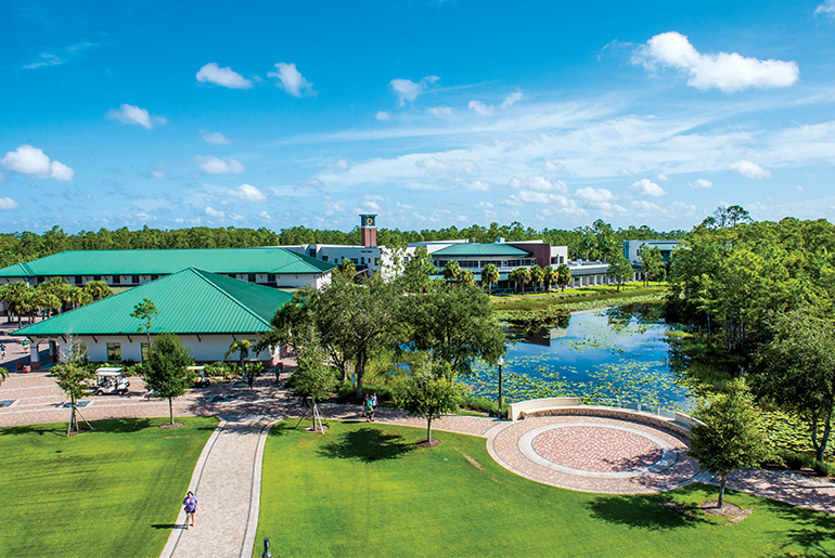 Aerial image of FGCU lake and campus green near library
